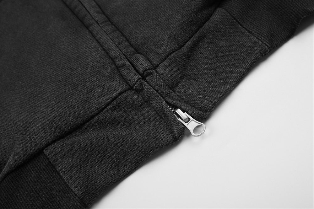 Close-up of black hoodie hem with silver zipper detail