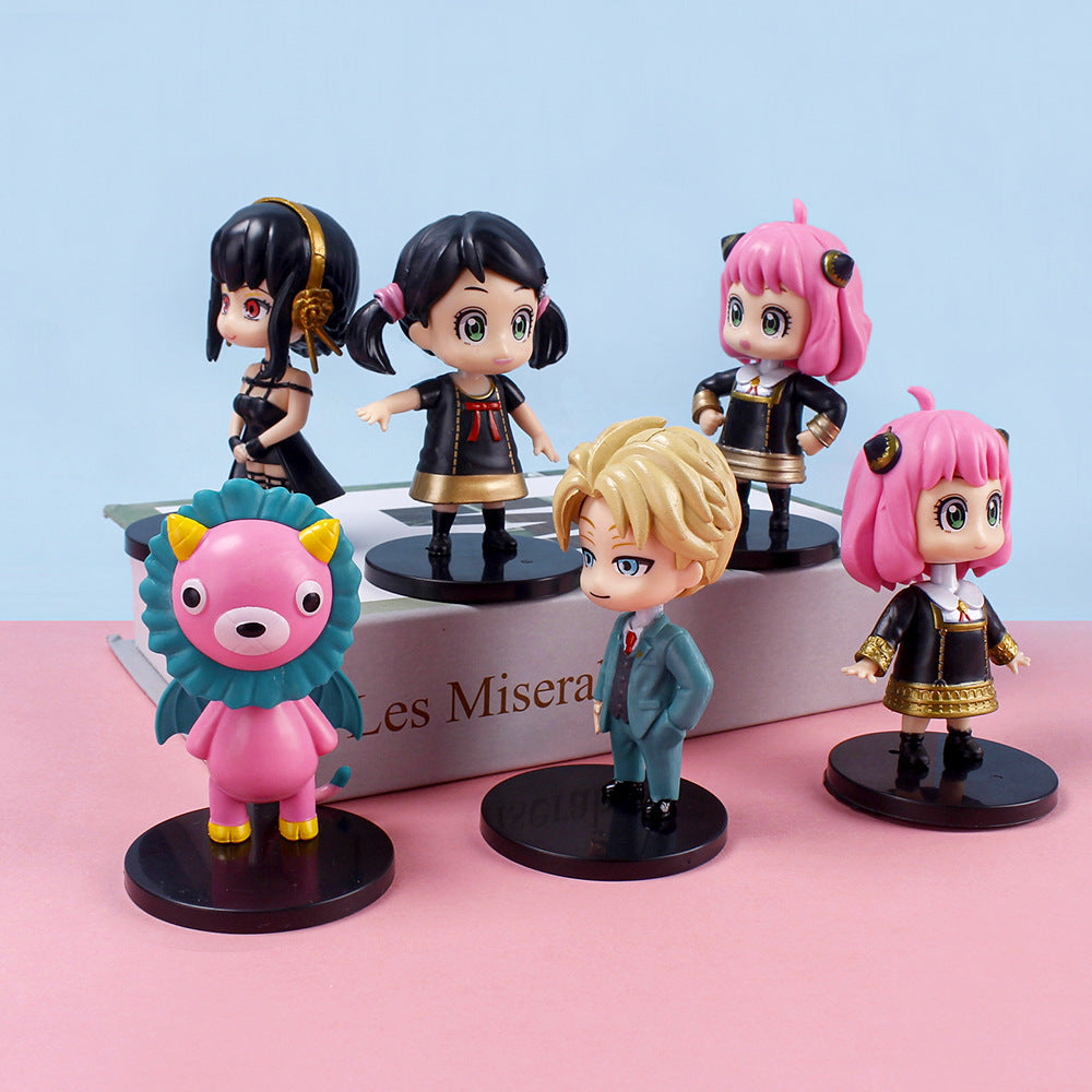 The Spy x Family 6-Piece PVC Figure Set features five human characters with unique styles and a pink cartoon lion, displayed on black bases. They are arranged atop and alongside a book titled &quot;Les Misérables,&quot; making it perfect for anime collectors.