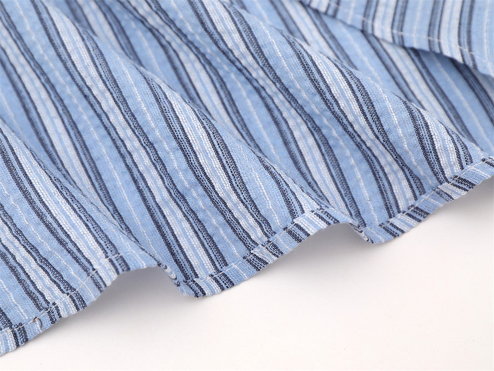 Blue striped shirt hem close-up with curved stitched edge