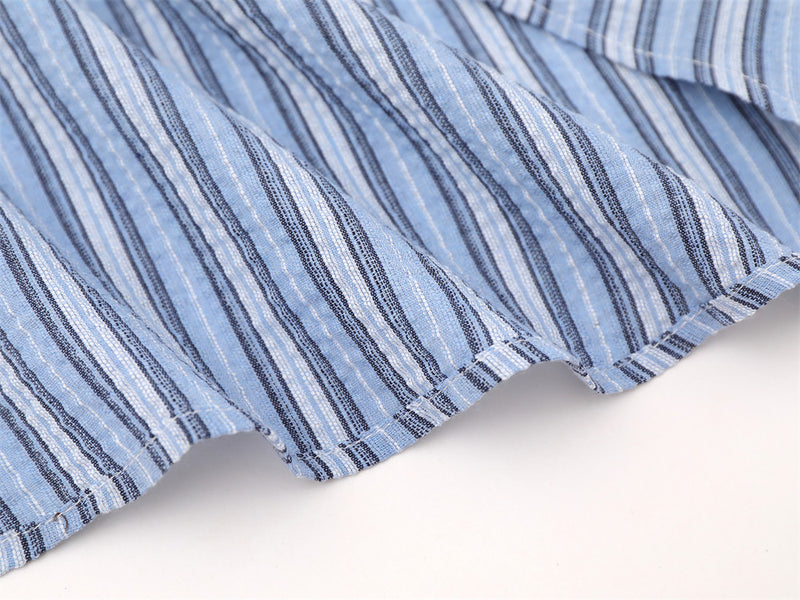 Blue striped shirt hem close-up with curved stitched edge