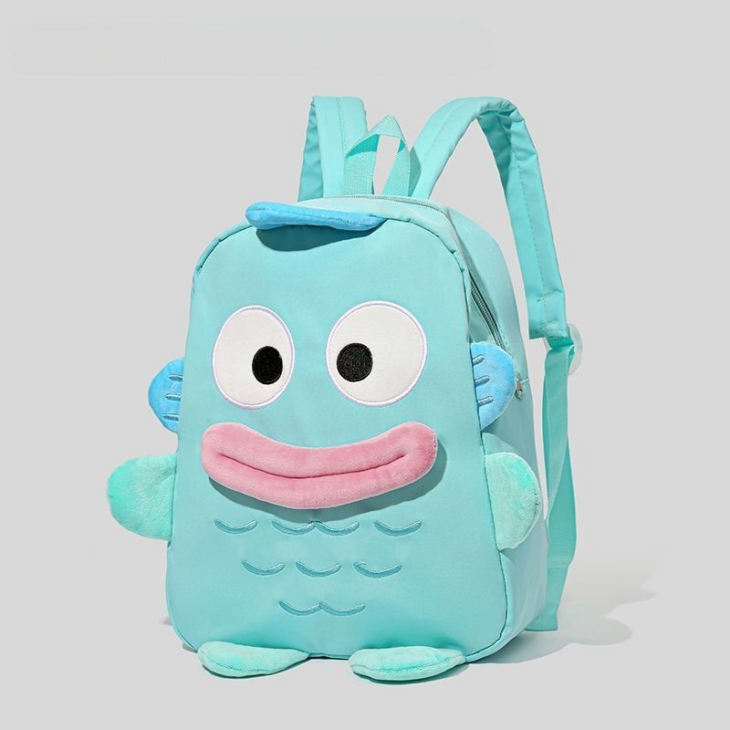 The Seakoff Adorable Clownfish Backpack for Kids features a playful fish design with a teal cartoon clownfish, round eyes, pink lips, and blue fins. It has an underwater theme with fish scale patterns, teal adjustable straps, and a top zipper against a plain gray background.