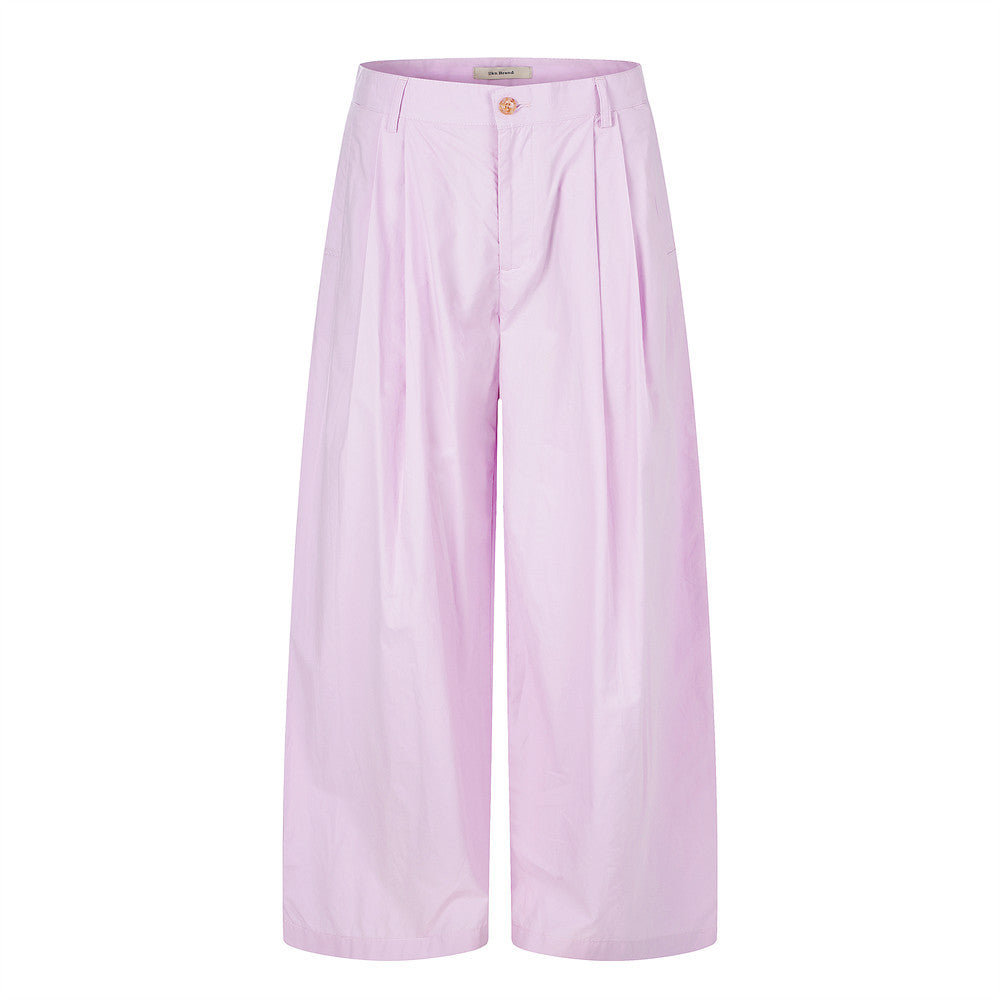 Wide-leg pleated trousers in lilac-pink with deep front pleats and a flared hem, front view