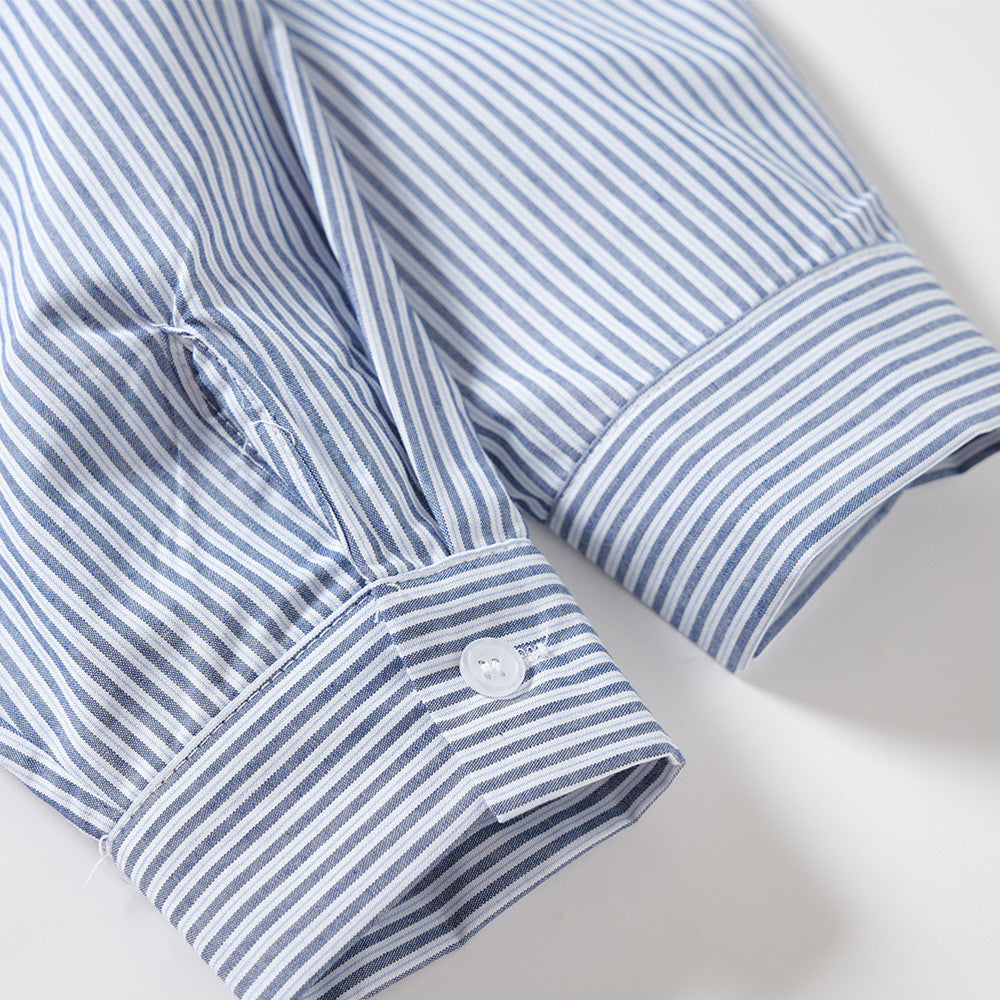 Close-up of a striped sleeve cuff with button detail