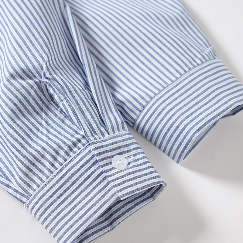 Close-up of a striped sleeve cuff with button detail