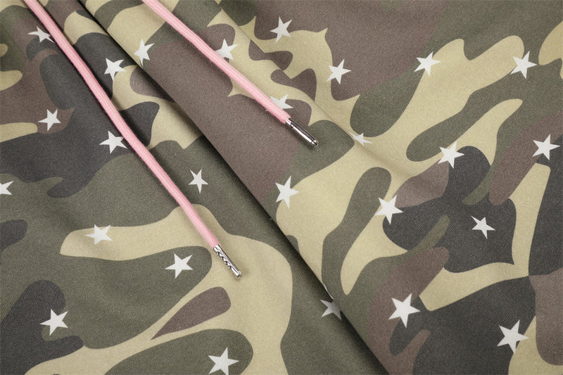 Close-up of pink drawstrings over camo star print fabric