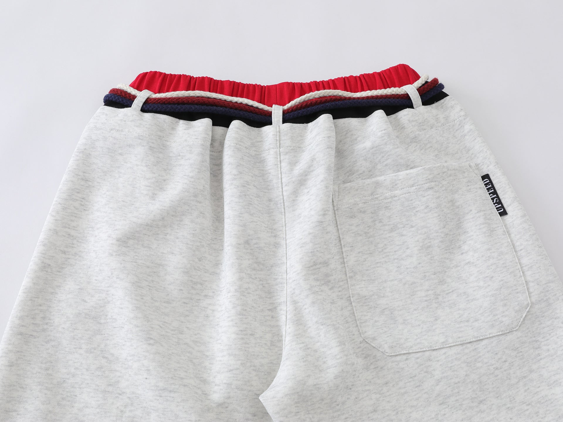 Pantalon de survêtement à jambes larges avec double ceinture et cordon tressé