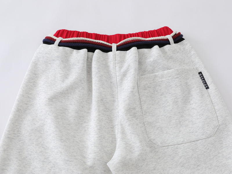 Pantalon de survêtement à jambes larges avec double ceinture et cordon tressé
