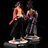 Displayed back-to-back on individual stands, the Demon Slayer figures include a Shinjuro Rengoku in a red robe with black hakama and sword, and another figure with spiky hair in purple cloth, each 29CM PVC action figures perfect for any Kimetsu no Yaiba fan collection.