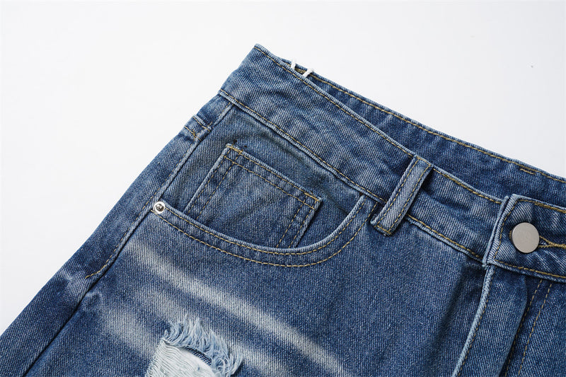 Close-up of front pocket and waistband on faded blue denim jeans