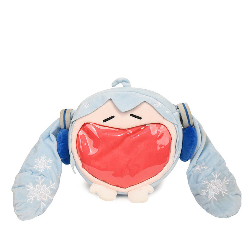 The Seakoff Cute Anime Hatsune Miku Backpack, a plush ita bag, features a character-inspired design in blue and white with long floppy ears adorned with snowflake patterns. Blue earmuffs and a large transparent red patch resembling an open mouth add charm, making it ideal for any anime merch collection.