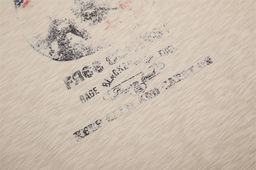 Close-up of printed text on beige tee front graphic near the lower chest