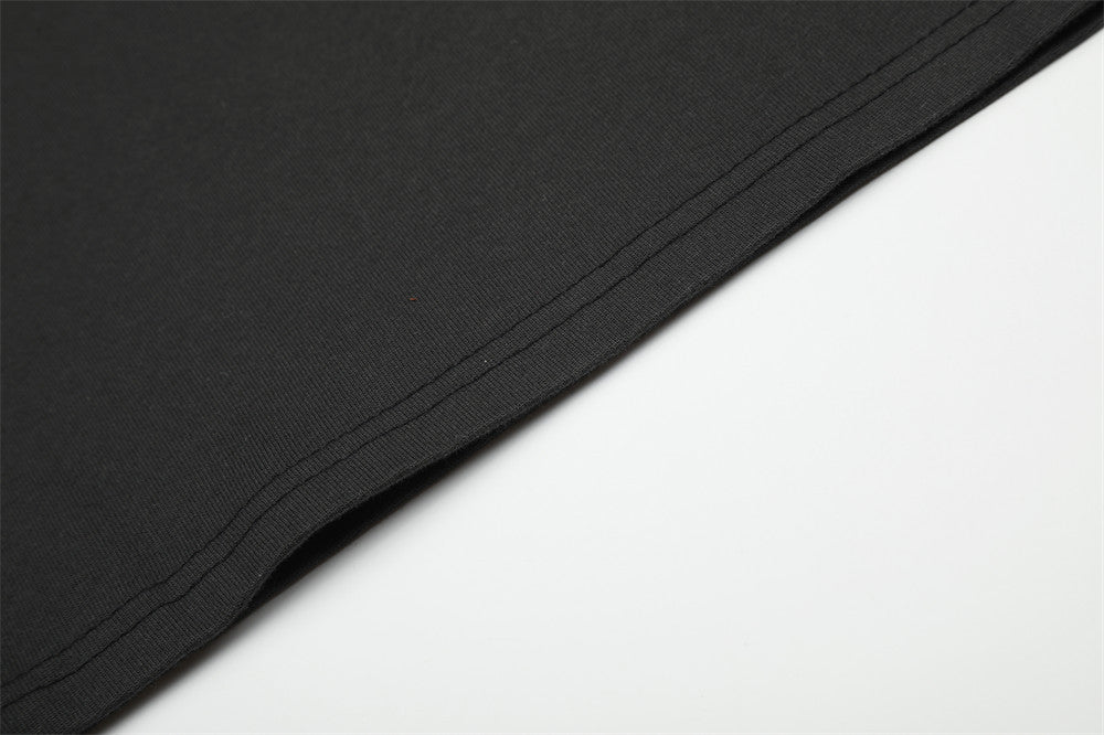 Close-up of black T-shirt hem stitching along the lower edge