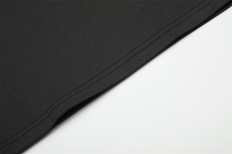 Close-up of black T-shirt hem stitching along the lower edge