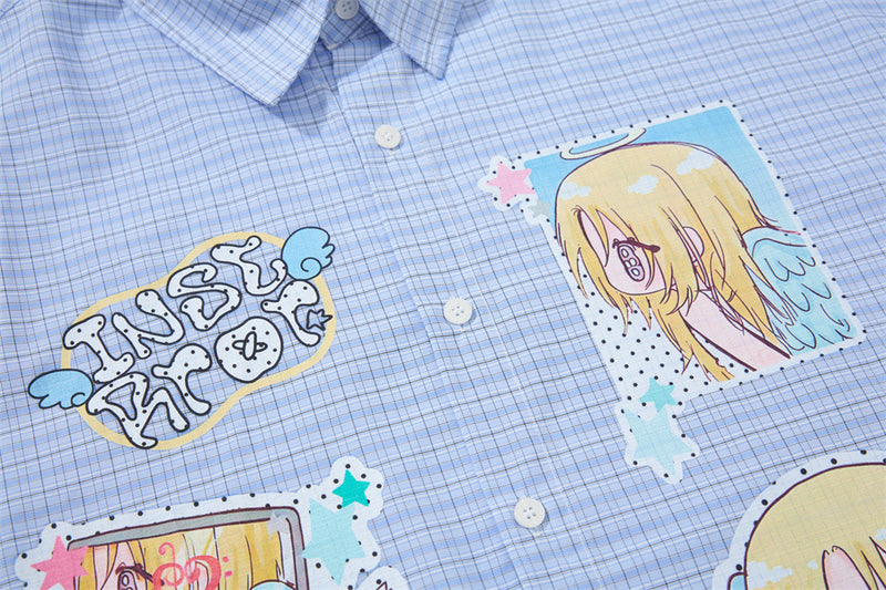 Blue plaid shirt front close-up showing anime graphic and button placket