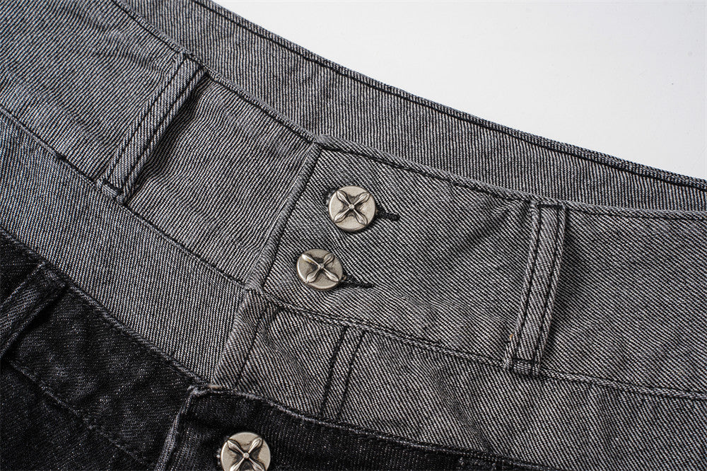 Close-up of gray denim waistband with two metal buttons and visible topstitching