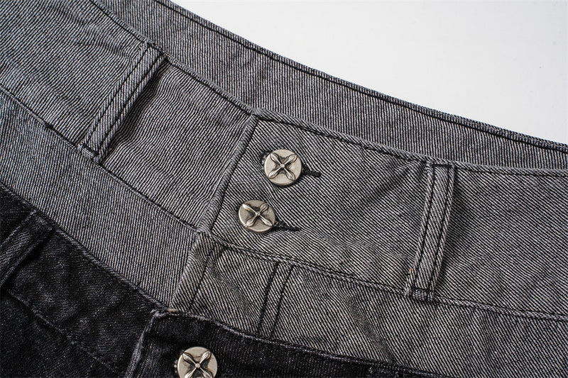 Close-up of gray denim waistband with two metal buttons and visible topstitching