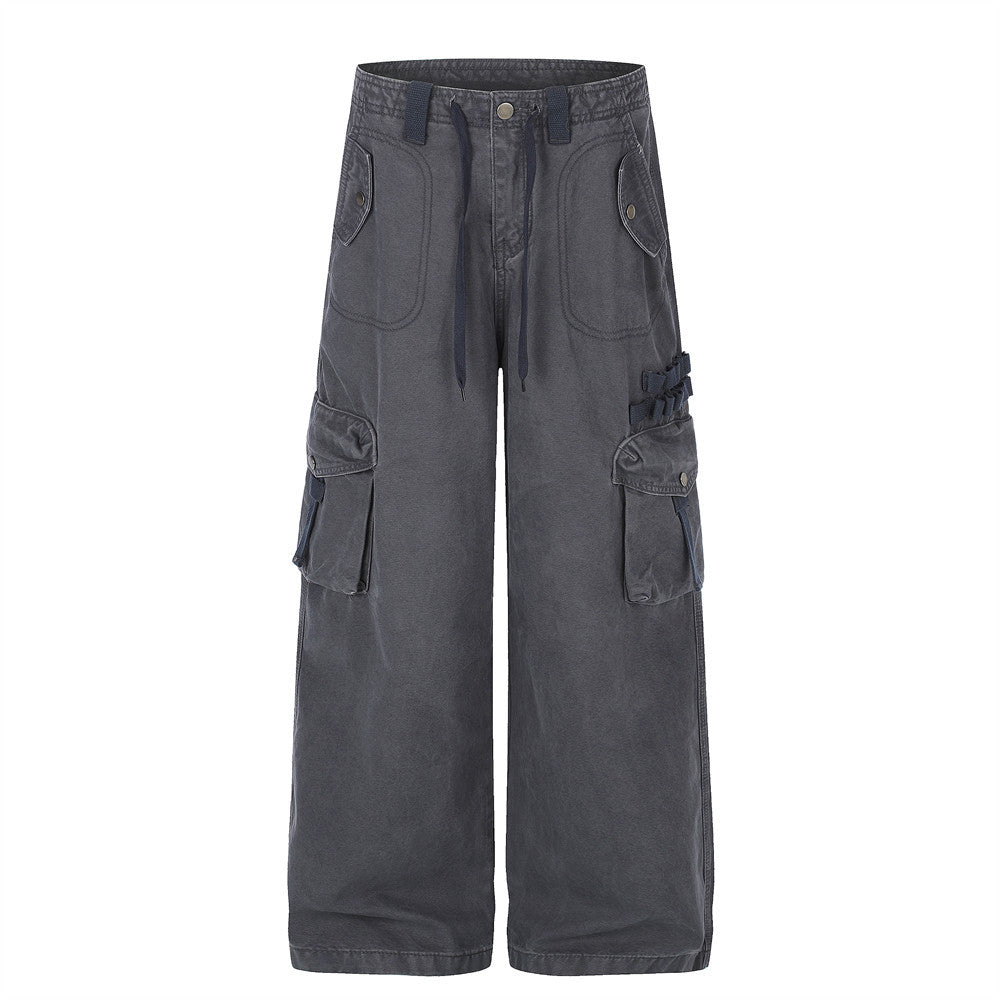 Baggy cargo pants men in washed grey wide-leg silhouette with multi-pocket cargo detail and buckle hardware