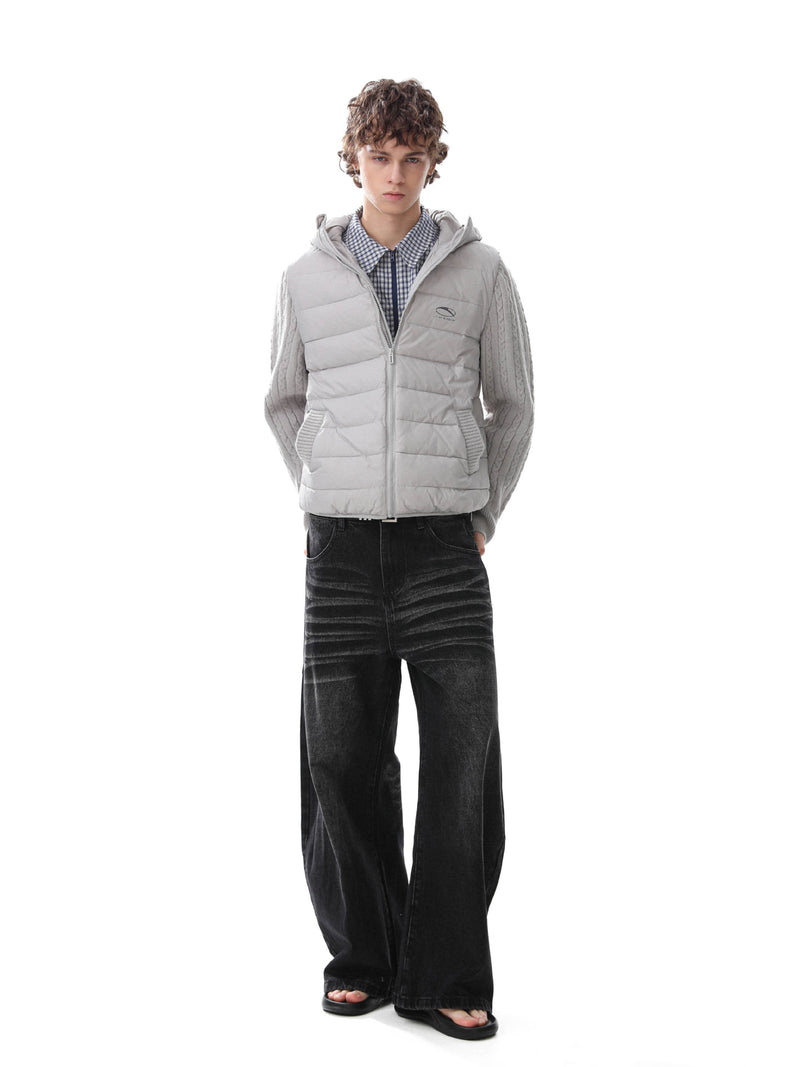 Hooded quilted puffer vest jacket with grey cable-knit sleeves, worn over a gingham shirt with wide-leg black jeans