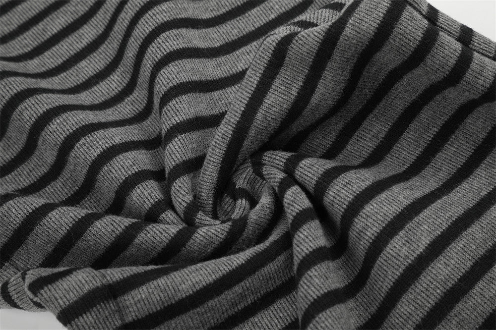 Close-up of black and gray striped knit fabric with twisted fold detail