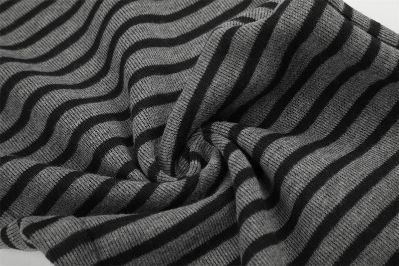 Close-up of black and gray striped knit fabric with twisted fold detail