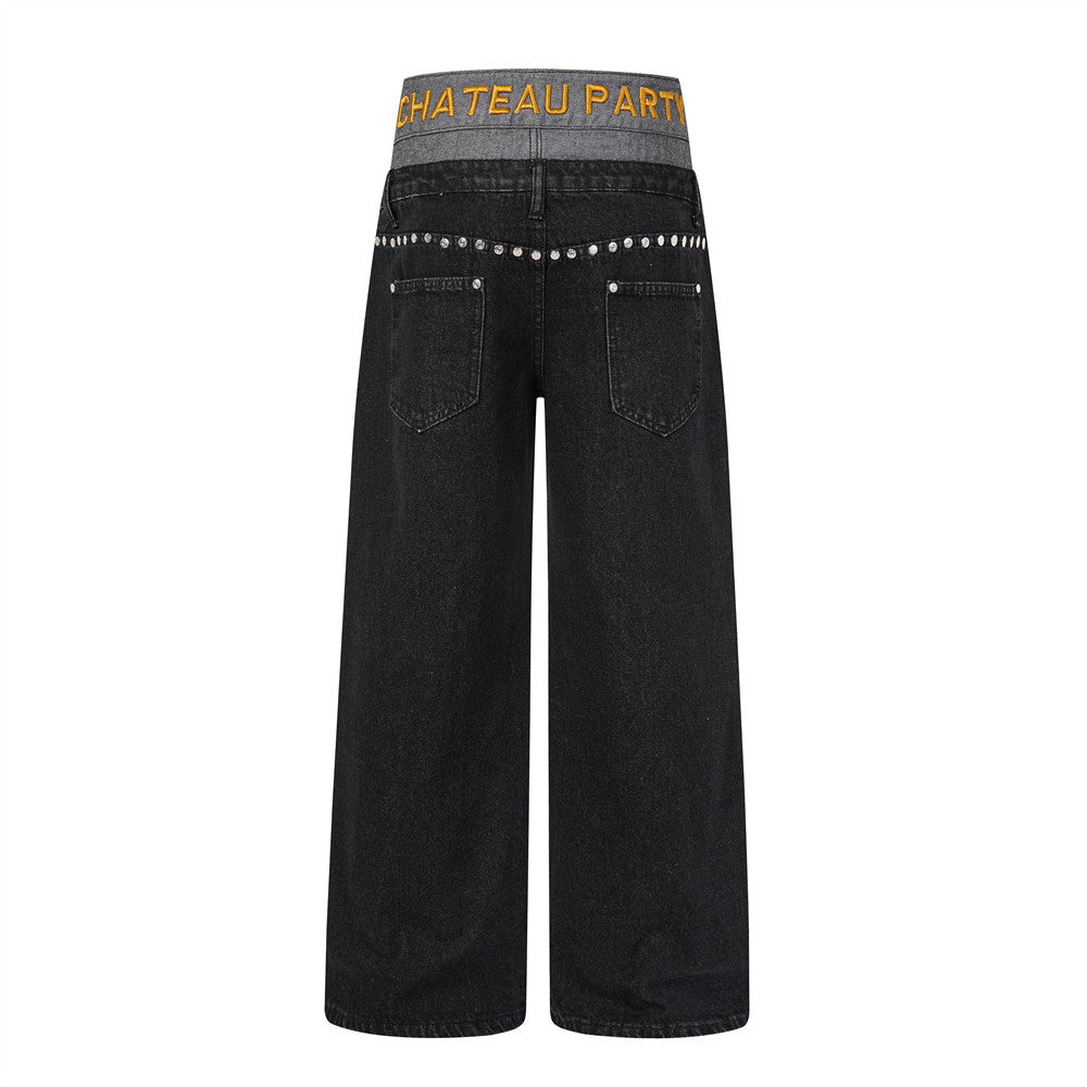 Back view of black wide-leg jeans with gray double waistband and silver stud trim