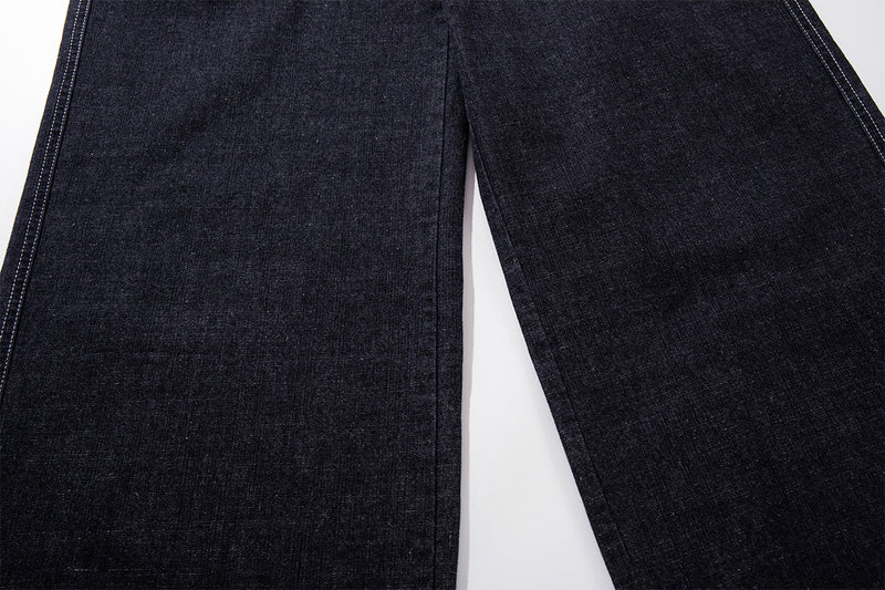 Vaqueros baggy de pierna ancha, lavado oscuro, bragueta diagonal de botones y denim crudo