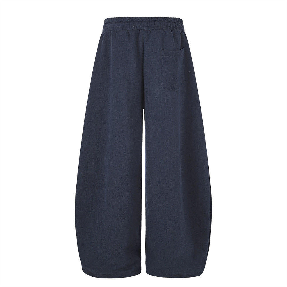 Navy wide leg sweatpants, back view with single patch pocket