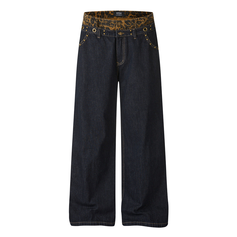 Men's dark indigo wide-leg jeans with leopard print double waistband and brass stud detailing by RHNDE
