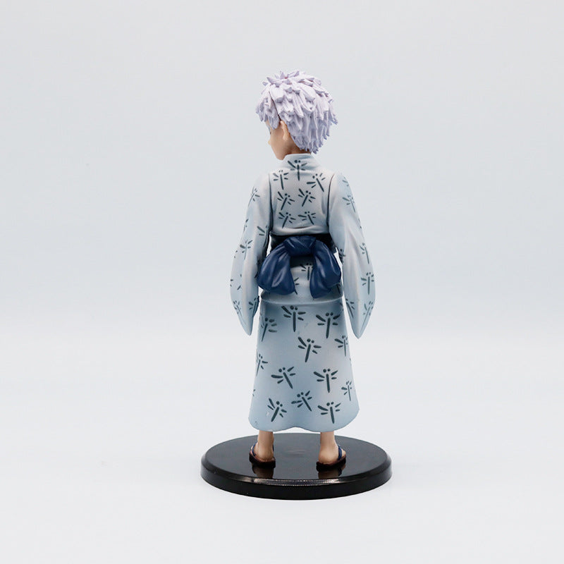 The Jujutsu Kaisen Satoru Gojo PVC Figure is an 18 cm collectible statue, featuring spiky white hair and a traditional yukata with dark patterns on light gray fabric, elegantly standing on a round black base.