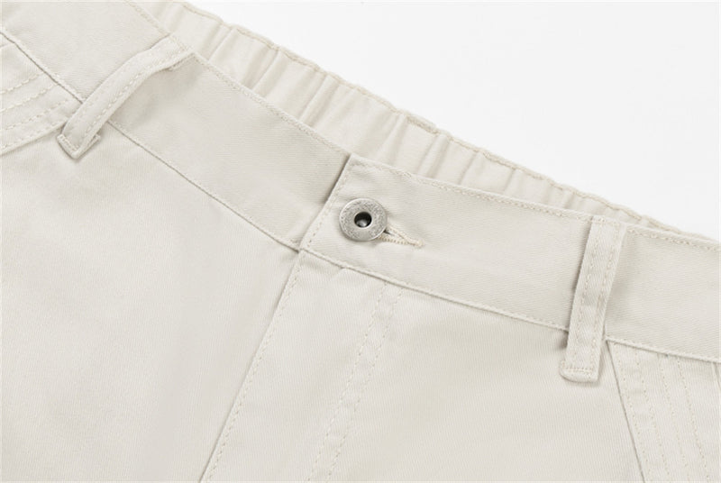 Close-up of cream pants waistband with button and belt loops