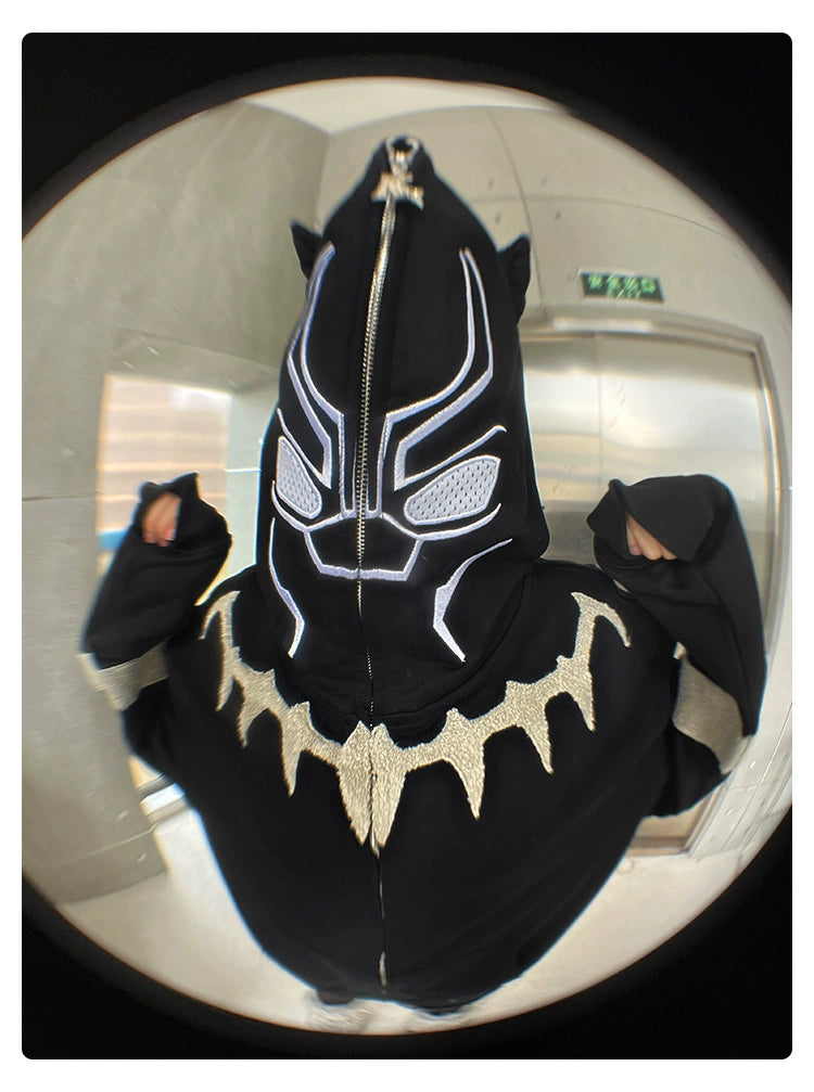 A person in a Seakoff Black Panther-Inspired Hoodie stands before a metallic elevator door. The fisheye lens captures the scene with curved distortion, making it an ideal snapshot for streetwear fans and those who admire the superhero aesthetic.