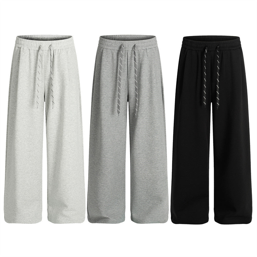 Pantalon de survêtement homme coupe ample à jambes larges, taille élastique à cordon, noir, vues de face et de côté