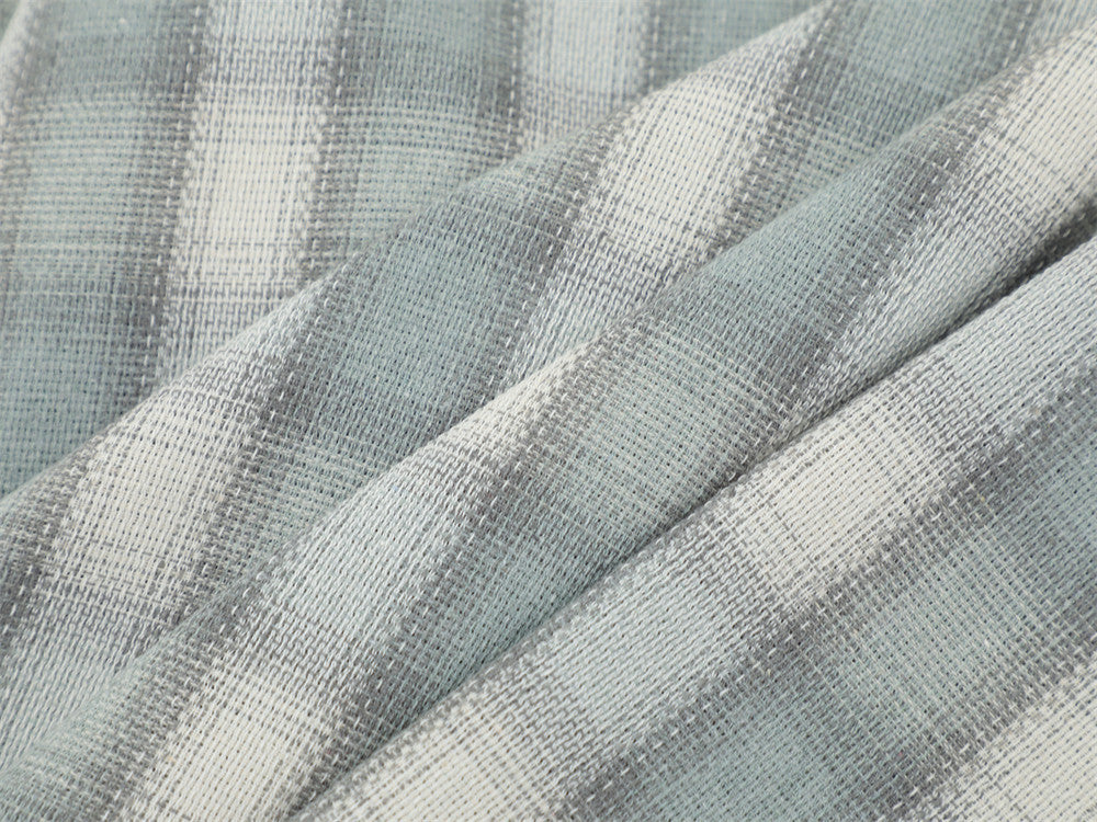 Close-up of light gray plaid flannel fabric with soft woven texture