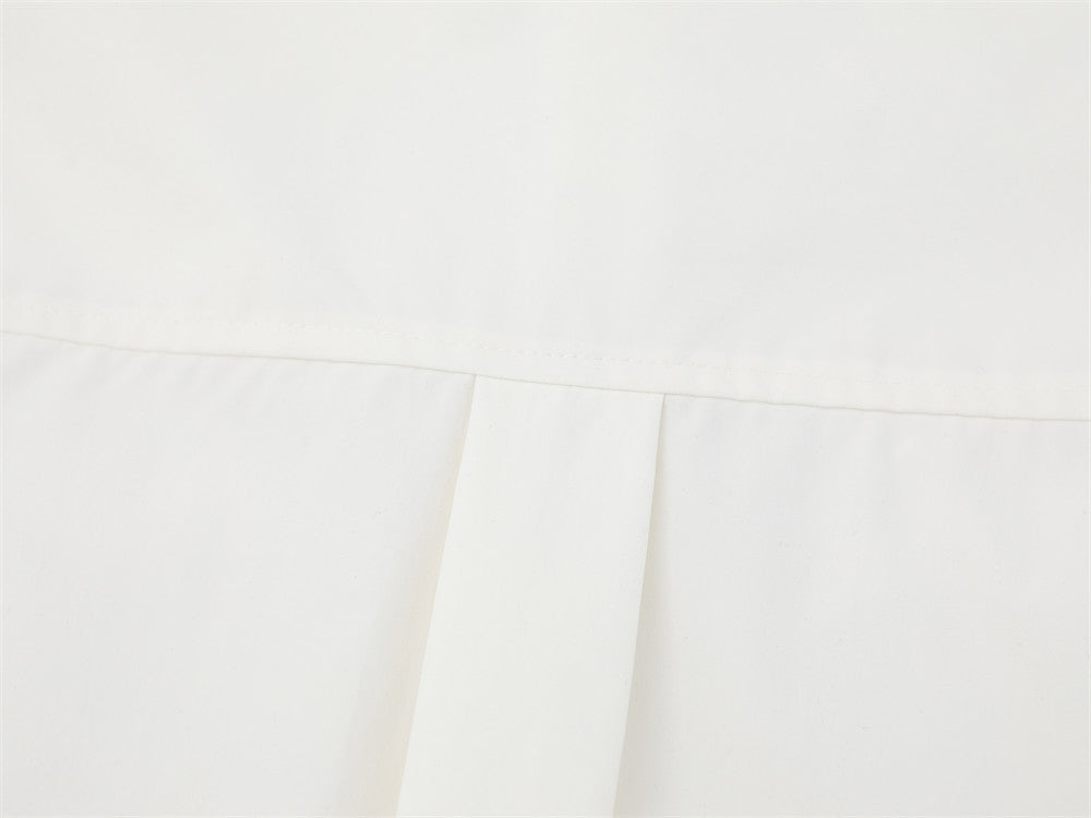 Close-up of white shirt back pleat detail below the yoke