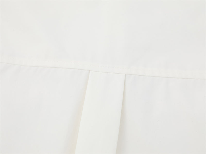 Close-up of white shirt back pleat detail below the yoke
