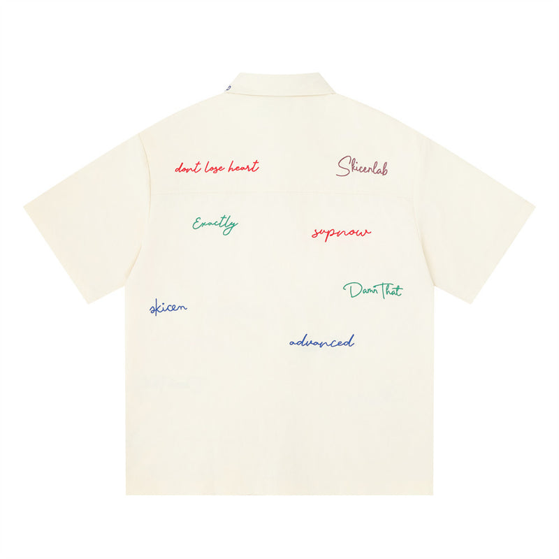 Cream short sleeve button-down shirt with multicolor graffiti script embroidery, back view