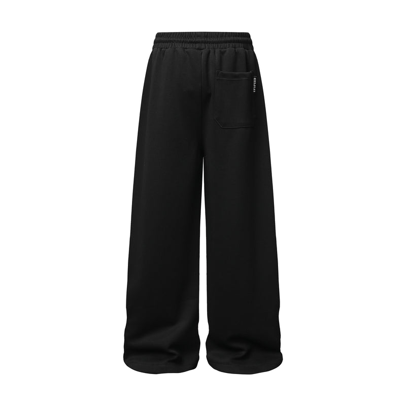 Pantalon de survêtement à jambes larges avec graphisme graffiti et ourlet orné de détails métalliques