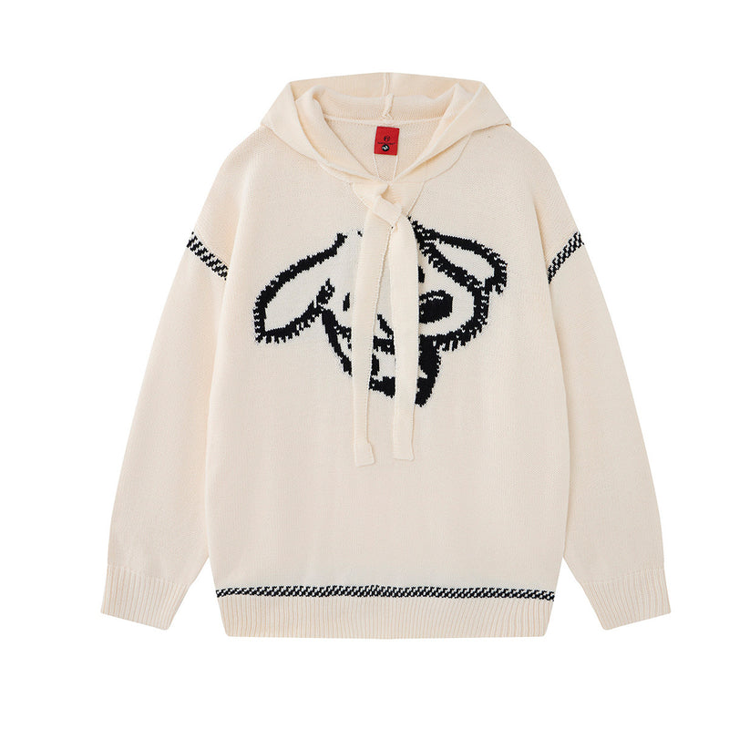 Pull à capuche oversize en maille jacquard crème, motif graphique noir marqué et bordures rayées pied-de-poule