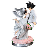 The Seakoff Goku and Chi-Chi Wedding Collectible Figure features the Dragon Ball Z duo in a wedding pose. Goku holds pink roses while Chi-Chi wears a white gown and veil on a rose-adorned base, perfect for fans.