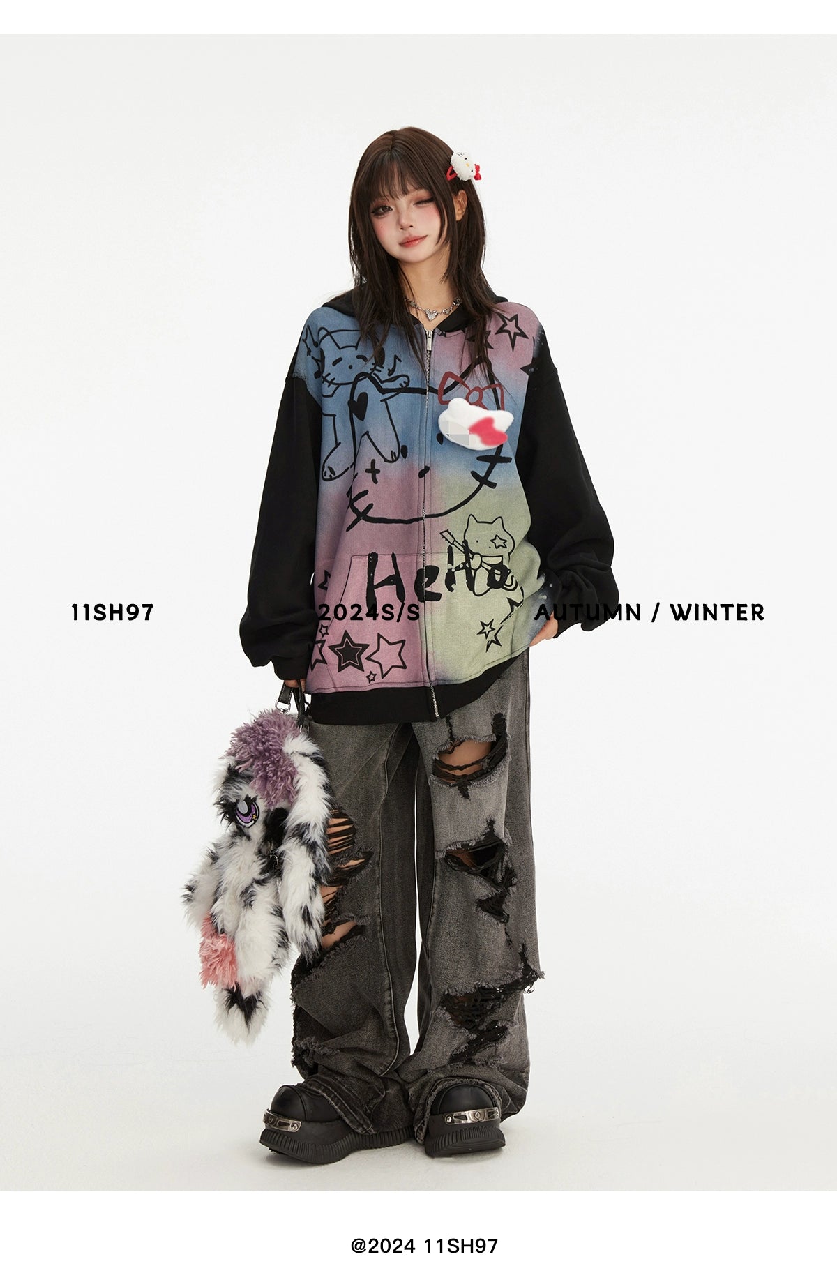 Dressed in an oversized Pastel Cat Graffiti Hoodie by Seakoff, paired with baggy ripped jeans and plush slippers, a person radiates streetwear vibes. Holding a stuffed animal, they embody kawaii charm. Image text: &quot;11SH97 2023/S Autumn/Winter @2024 11SH97.