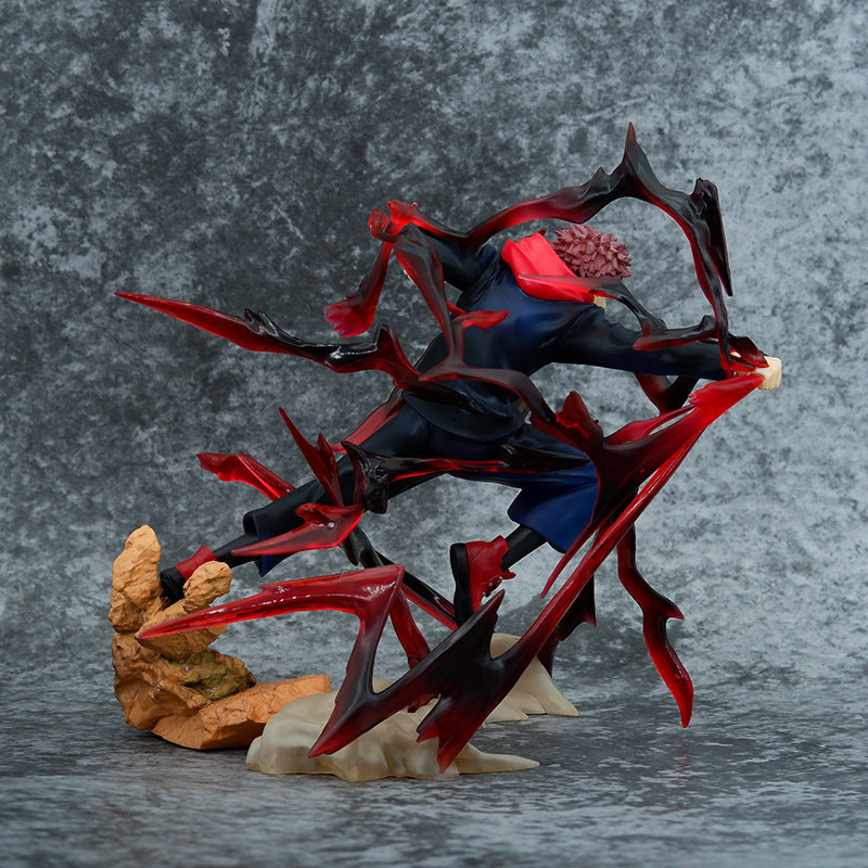 The Jujutsu Kaisen Yuji Itadori PVC Figure features Yuji in a dynamic pose with cursed energy, showcasing his spiky hair and dark outfit with a red scarf, all on a textured rock-like base.