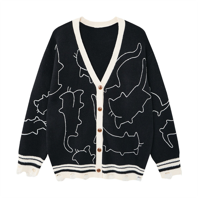 Cardigan oversize en maille à col V avec broderie représentant le contour d’un chat blanc, bordures contrastantes crème et ourlet effet usé, coloris noir