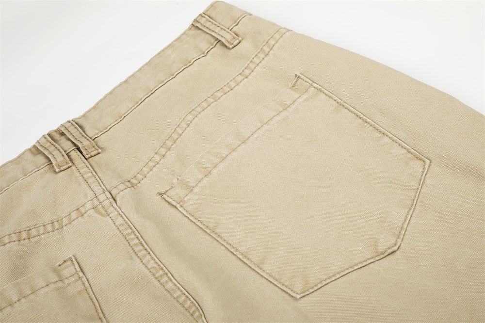 Close-up of beige cargo pants back pocket with stitched outline and belt loops