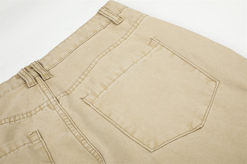 Close-up of beige cargo pants back pocket with stitched outline and belt loops