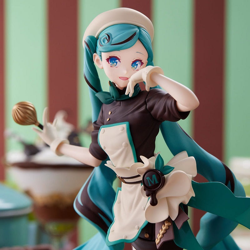 This delightful Hatsune Miku 21cm PVC figure, dressed as a Black Chocolate Pastry Chef, features a blue-haired character in a pastry chef outfit with whisk, white and teal hat, gloves, apron with bow, and set against blurred green and brown stripes.