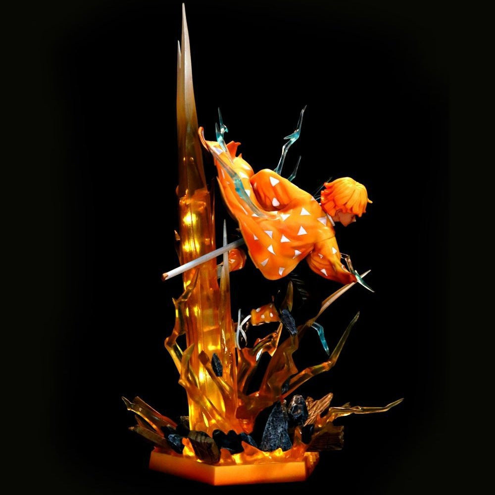 The Rengoku Kyojuro Demon Slayer Flame Hashira Figure features the character in an orange robe with white triangles, striking a mid-air pose. The 350mm figure includes a light-up base adorned with sharp translucent spikes and vibrant orange-yellow accents, resembling an explosive energy burst.