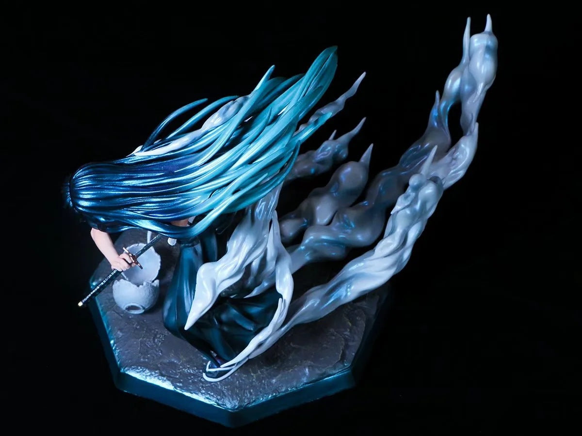 The Muichiro Tokito Demon Slayer Figure, an 18cm premium PVC collectible, shows long teal hair and a dark outfit wielding a sword with ghostly mist effects. The hexagonal base has a stone-like texture and complements the dramatic look.