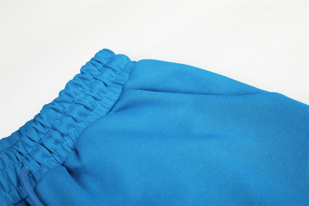 Close-up of blue sweatpants elastic waistband and gathered top seam