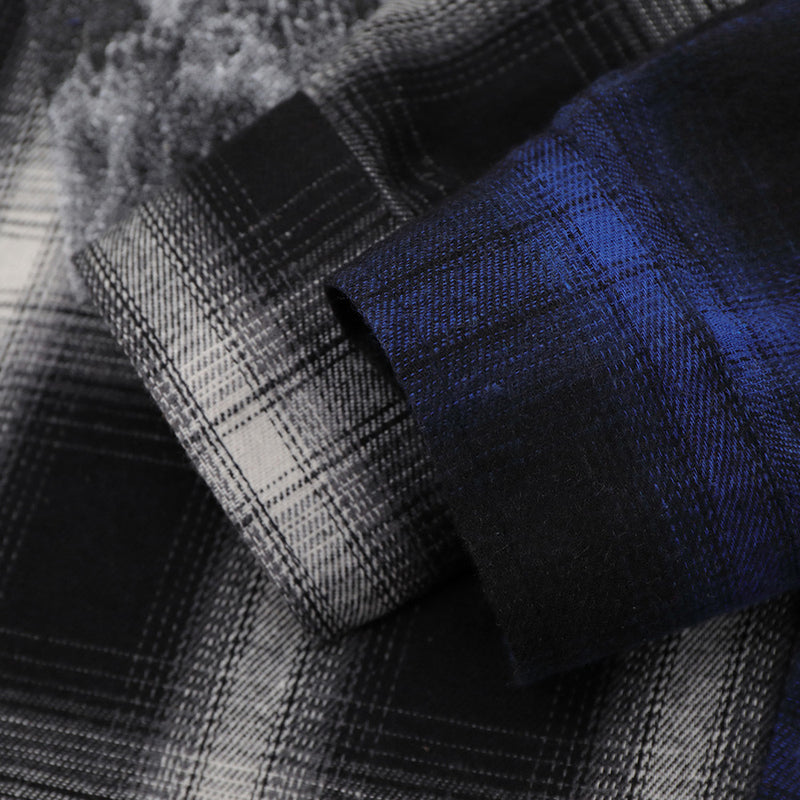 Close-up of cuff and sleeve fabric on blue plaid colorblock shirt