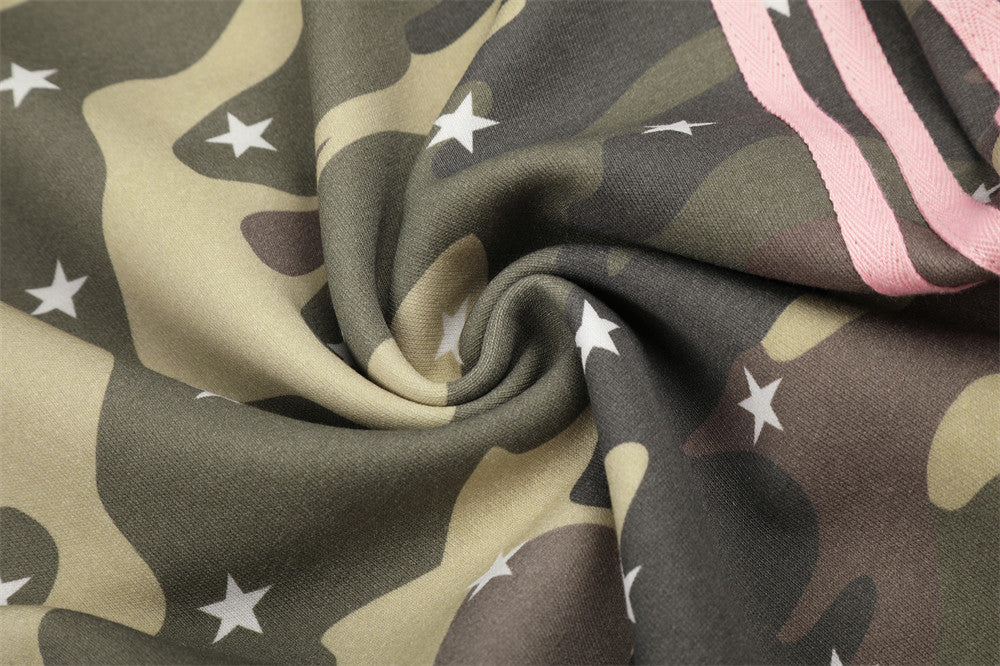 Close-up of camo star print fabric with pink stripe trim
